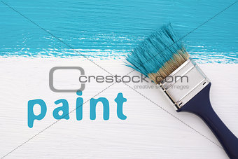 Stripe of turquoise paint, paintbrush and the word PAINT