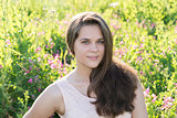 Portrait of girl of 16 years in flower meadow