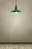 green lamp in front of a brown wall