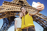 mother and child tourists taking selfie against Eiffel tower
