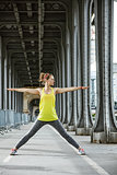 woman jogger stretching on Pont de Bir-Hakeim bridge in Paris