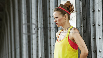 healthy woman looking into distance on Pont de Bir-Hakeim bridge