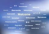 Welcome phrases in different languages of the world on blue blurred background