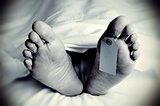 dead body with a blank toe tag, in monochrome