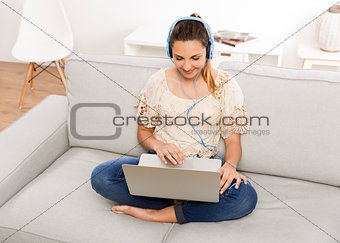 Woman listen music on her laptop
