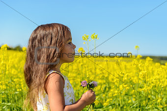 Portrait of a girl in rapeseed field