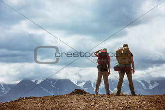 Man and woman on mountains backdrop