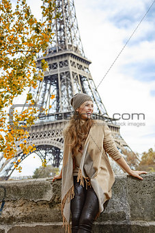 young elegant woman on embankment in Paris exploring attractions