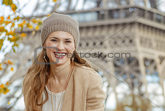 tourist woman sitting on parapet on embankment near Eiffel tower