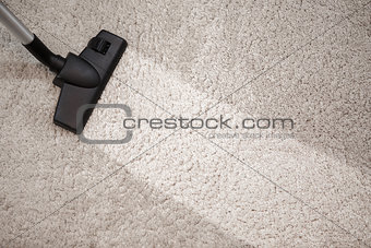Head of vacuum cleaner in dusty carpet and clean strip