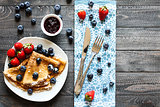 Delicious Crepes Breakfast with Dramatic light over a wood background