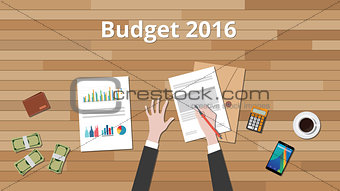 budget 2016 illustration with hand business man work on wooden table with graph and chart and paper document with money