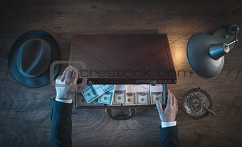 Rich businessman with dollar packs