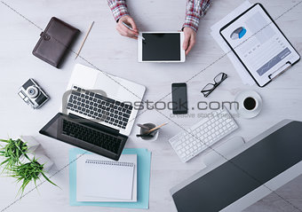 Businessman working at desk with a digital tablet