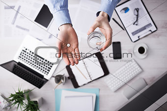 Office worker taking a pill