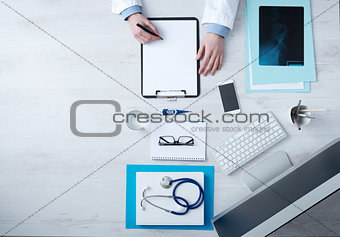 Doctor writing medical records