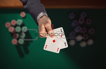 Poker player holding two aces