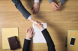 Business people handshaking after signing an agreement