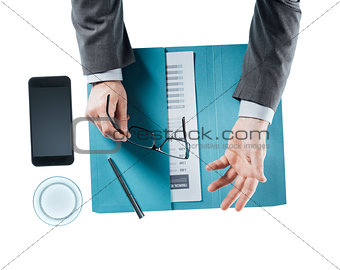 Businessman holding glasses and talking