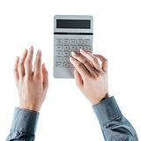 Business woman using a calculator