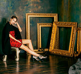 beauty rich brunette woman in luxury interior near empty frames,