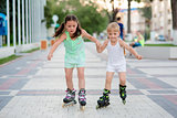 two beautiful little sisters in a roller skates