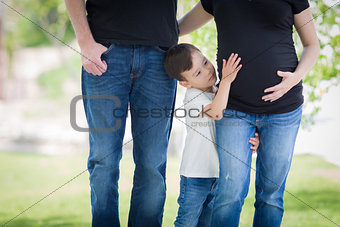 Young Mixed Race Son Touches Pregnant Belly of Mommy