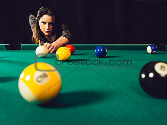 Beautiful woman playing pool