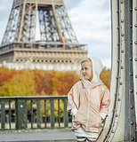 active child on Pont de Bir-Hakeim bridge in Paris looking aside