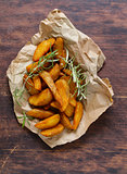 slices of fried potatoes with rosemary and spices