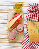 traditional Italian ciabatta bread with cheese, sausage, tomatoes and olive oil