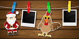 Blank photo frames, rooster and Santa Claus on a clothesline.