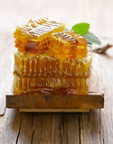 natural organic honey, honeycombs on a wooden table