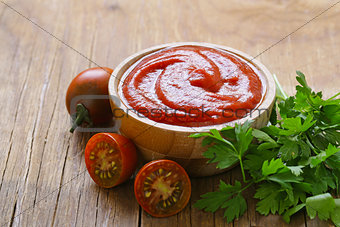 tomato sauce (ketchup) in a wooden bowl