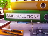 Green Office Folder with Inscription SMB Solutions. 3D Rendering.
