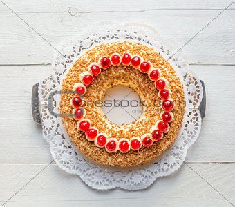 Frankfurt crown cake with cherries on white wooden