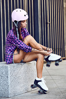 Young woman wearing roller skating shoe outdoors lifestyle portrait