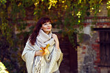 Beautiful girl outdoors with autumn leaves