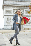happy trendy fashion-monger with shopping bags in Paris, France