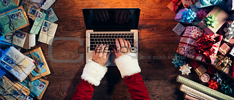 Santa typing on a laptop