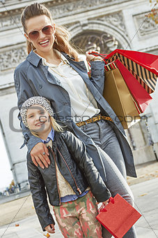 happy mother and child near Arc de Triomphe in Paris, France