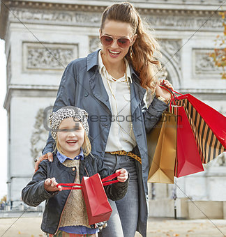 mother and child having fun time near Arc de Triomphe in Paris