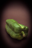 Green pepper isolated on a brown background