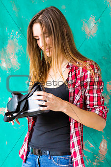 technology, VR, entertainment and people concept - happy young woman with virtual reality headset or 3d glasses