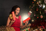 Woman opening a gift box.Christmas season