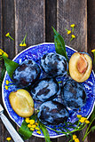 Fresh  ripe blue plums on plate