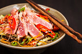 Grilled tuna and  asian rice glass noodles with vegetables 