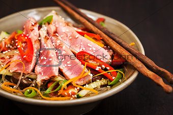 Grilled tuna and  asian rice glass noodles with vegetables 