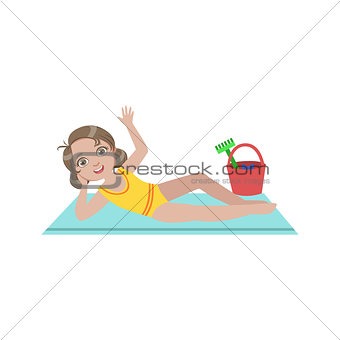 Girl On Beach Blanket With Plastic Bucket Of Toys