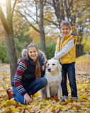 Kid and dog in autumn park